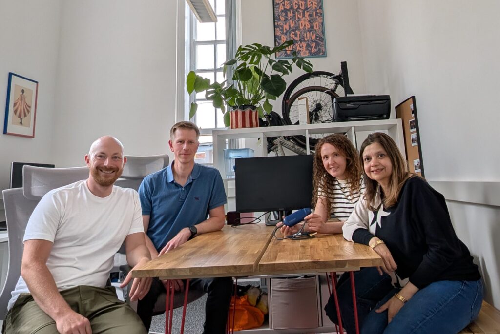 Group of colleagues sitting around a desk