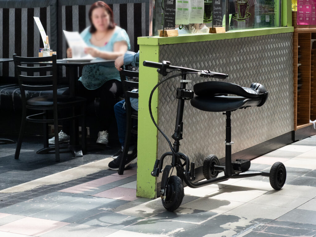A mobility scooter parked outside a cafe in the Grainger Market